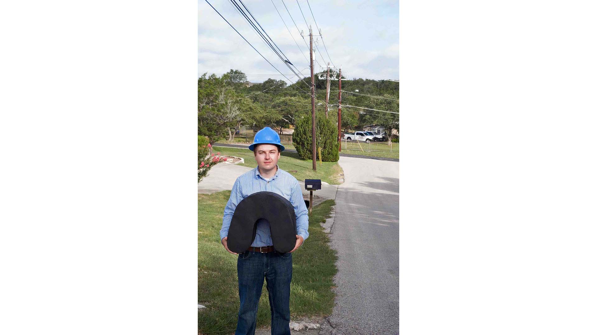 An engineer holds the custom spool-free cable coil used for aerial fiber deployment